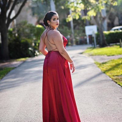 Prom 2019 Dress Ideas from a girl in a long red prom dress with strappy open back